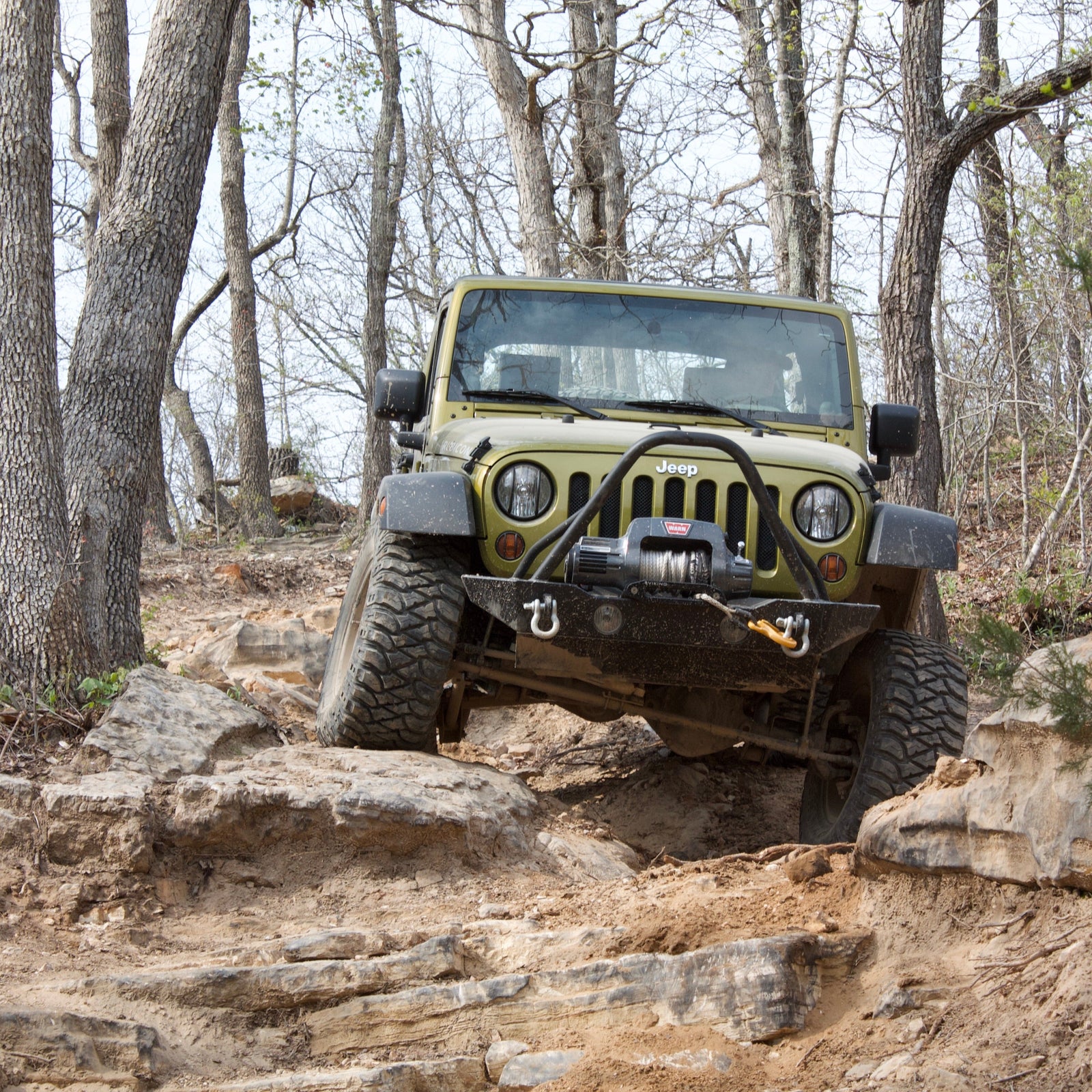Calibrated Jeep Wrangler climbing rocks